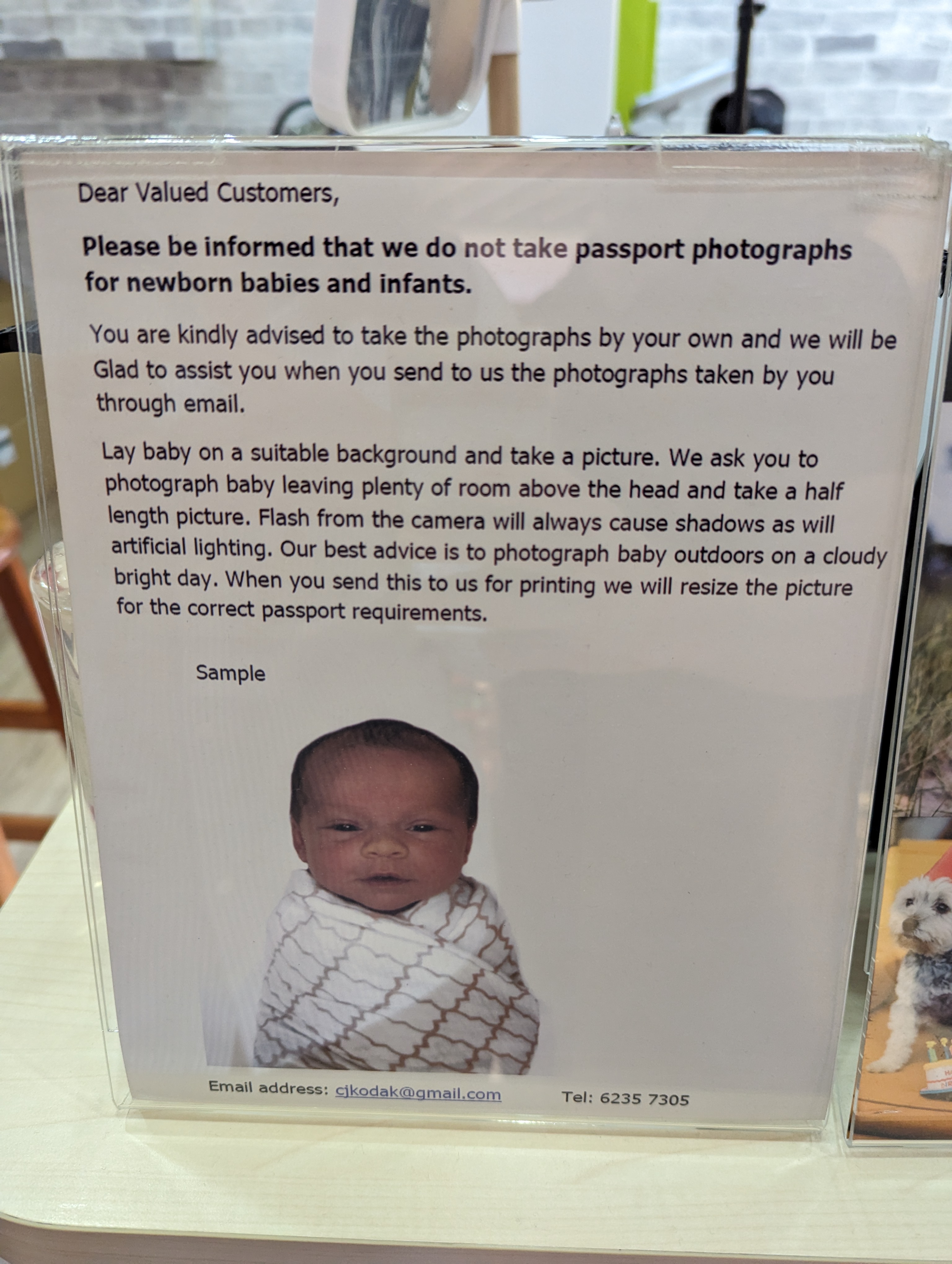 A sample baby passport photo shown on an instruction sheet